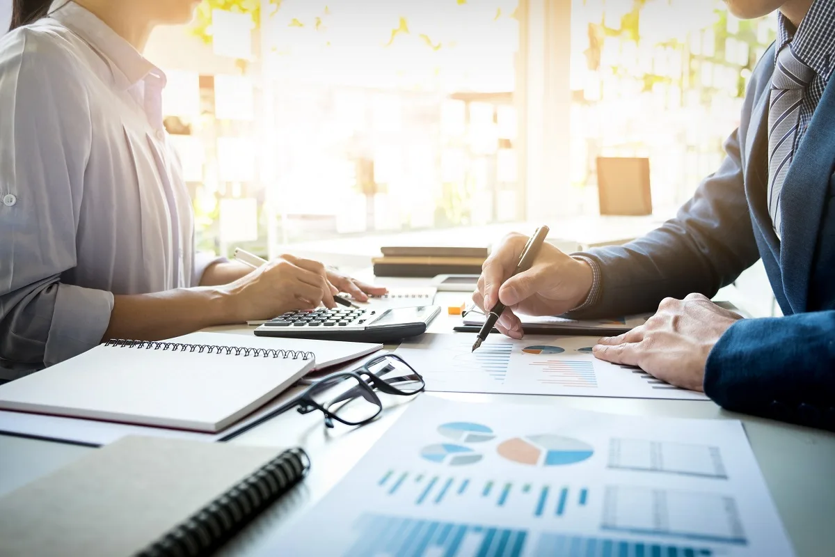 Financial advisors analyzing reports and loan documents for Low Doc and credit-impaired clients.